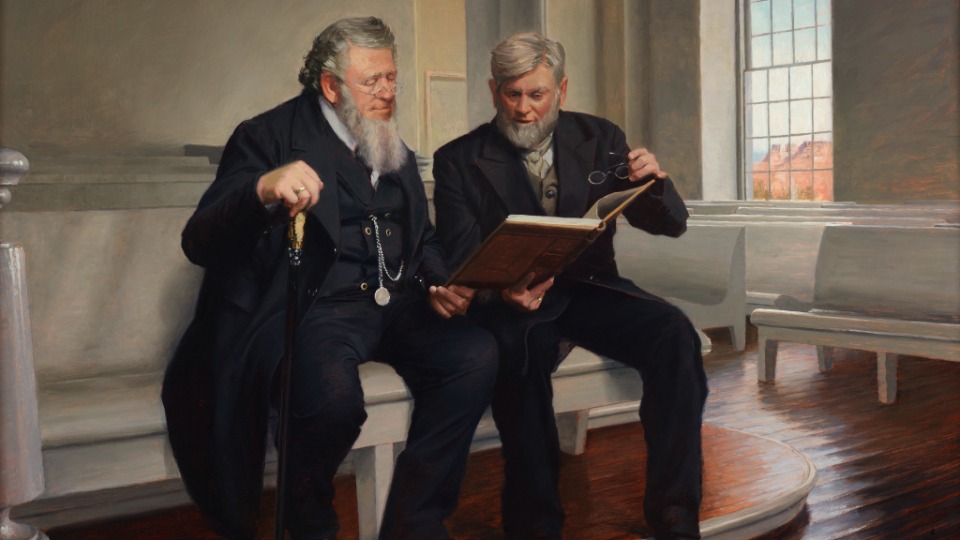 Esta pintura de Casey Childs representa a Wilford Woodruff (derecha) en la sala de reuniones del St. George Utah Temple muestra a Brigham Young (izquierda) el trabajo que se le pidió que hiciera para codificar la investidura del templo.